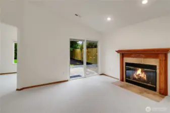 Living room off kitchen with gas fireplace and backyard access