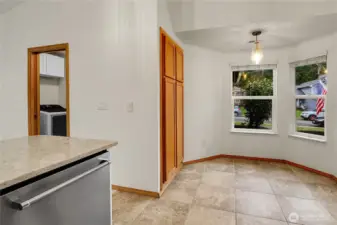 Kitchen with breakfast nook, heated floors, stainless steel appliances, vaulted ceilings, and quartz counters