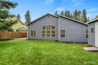 Level, fully fenced backyard with shed