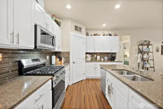 Kitchen with sink in island and propane range.
