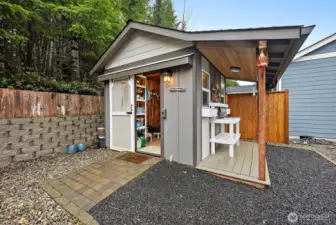Adorable storage shed with additional covered area