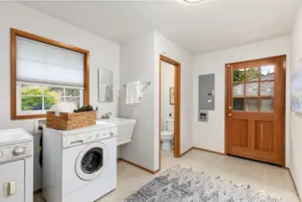 Laundry room has sink and half bath and access to the outside with huge closet.