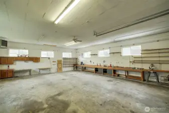 The shop interior is lined with work benches and also features a gas overhead shop heater.