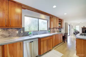 The kitchen features gorgeous hardwood cabinets, tile countertops and stainless appliances.
