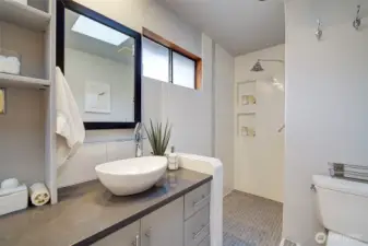 The primary bath includes modern finishes and features a walk-in shower.