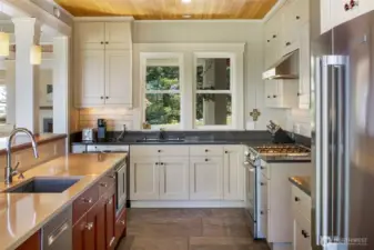Well-appointed kitchen with gas range, subway tile backsplash, and abundant storage designed for everyday living and entertaining.