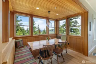 Charming breakfast nook with wraparound windows capturing stunning valley and water views—perfect for everyday dining.