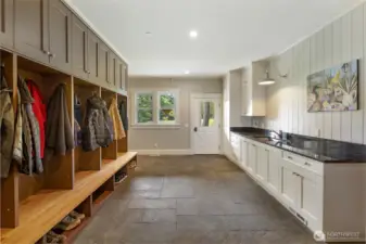 Well-designed mudroom with built-in storage, bench seating, and utility sink—perfect for island living and outdoor lifestyle.