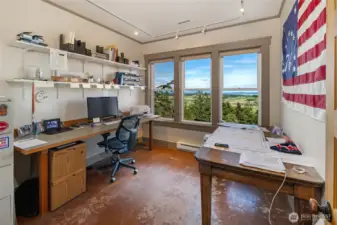 Dedicated office with built-in workspace and large windows capturing expansive valley and water views—ideal for working from home.