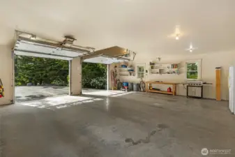 Oversized garage with ample room for vehicles, storage, and workspace, offering flexibility for a variety of uses.
