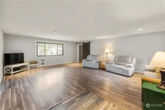 Step into the large, bright living room featuring expansive hard surface flooring.