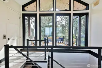 Coming up to the main level. Elevator door to the left or come up the stairs. Front covered deck.