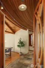 Inside, wood-wrapped ceilings and slate floors set the tone, while artful angles and graceful curves add visual intrigue throughout