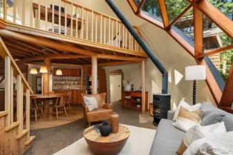 Cozy up by the wood-burning fireplace, where geometric dome windows surround you with views of the forest, making it feel like you're outdoors even in the heart of winter.