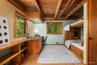 One of two main floor bedrooms, this room features a custom wood built-in desk and matching bunk bed—blending function with craftsmanship.