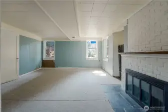 Another angle of Lower level family/living room with wood fireplace