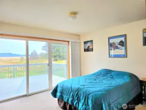 Primary Suite Sliding glass door to front deck.