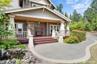 Well manicured with mature landscaping and a welcoming porch