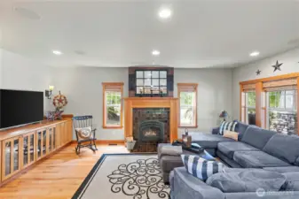 The living room is impressive with the custom built in buffet, wood burning fireplace and large windows overlooking the back of your property....you might just see wildlife.