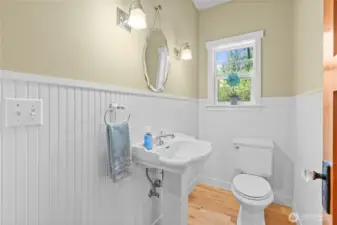 Main floor powder room with chair railing compliments the character of the home