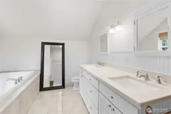 Primary bath features a jetted tub, dual sinks and a walk in shower