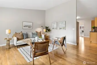 Front living room to kitchen. The hallway to the bedrooms is on the right.