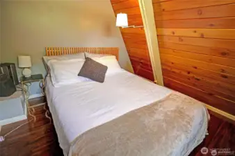 Spacious loft bedroom with magical water and mountain views.