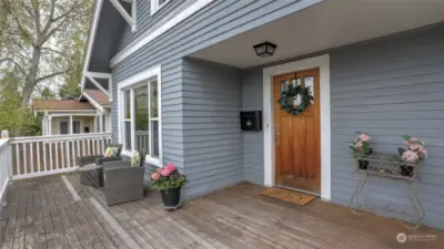 Large front deck and covered entry greets your guests.