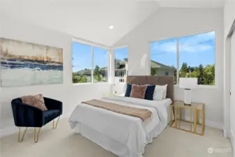 Bright and airy master bedroom with vaulted ceilings and large windows offering plenty of natural light.