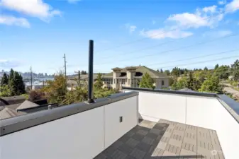 Expansive private rooftop patio, an ideal space for outdoor relaxation with panoramic city views.