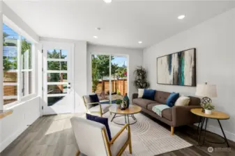 Bright living area with large windows that bring in natural light, perfect for relaxing.