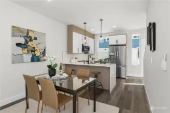 Open kitchen and dining area featuring modern lighting and top-of-the-line appliances.