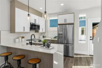 Stylish kitchen with a combination of sleek cabinetry, stainless steel appliances, and quartz countertops.