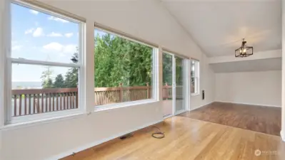 Living room flows into the dining room and easy access to the deck