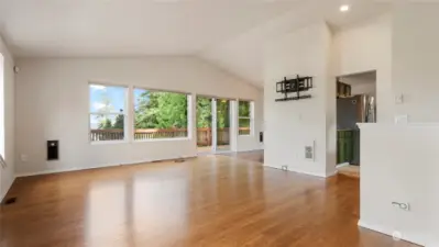 Another angle of the living room that flows into the kitchen and dining room-open and bright