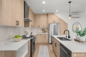 Where design meets function, from the waterfall island to the sleek matte black fixtures, every detail in this kitchen was thoughtfully curated for high-style living.