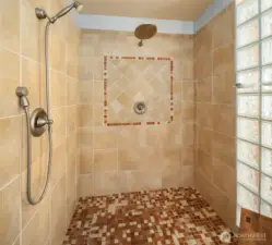 The beautiful glass block shower has full tile surround and is as large as it looks in this picture.