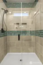 Spacious walk-in shower w/ glass door.