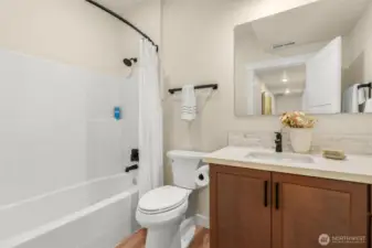 Lower full bathroom in hallway.