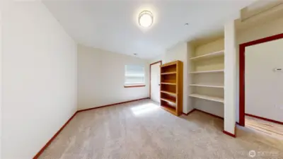 ADU bedroom w/ shelving & closet