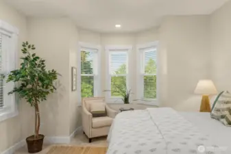 Primary bedroom has a bay window sitting area.