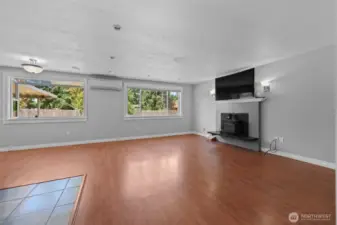 Main living area upon entry--multiple windows to back yard, wood stove, ductless heating/cooling, recessed lighting.