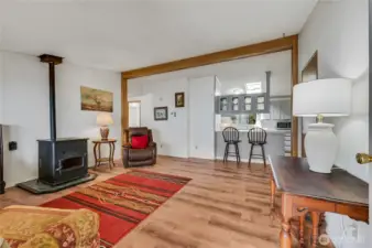 View of living space & kitchen bar from front door.