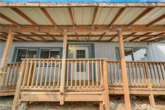 Unattached deck & roof to front door.