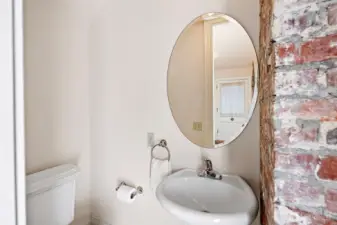 Convenient powder room located off the entry way and at the base of the stairs.