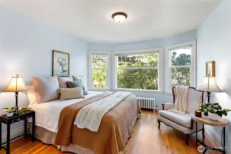 Primary bedroom with large bay window and spacious walk in closet.