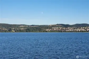 Long view of property (property is treed area) from the water.