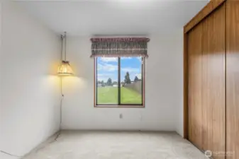 2nd bedroom at back of home with a view of the open space.