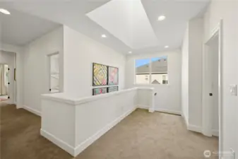 Spacious and bright hallways and stairwell, brightened by skylights above.