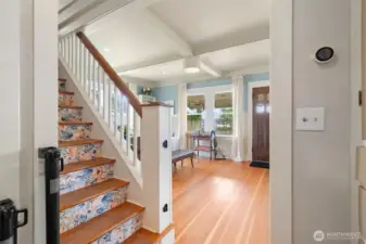 From kitchen into formal dining room on left and living room on right. Stairs to primary suite.